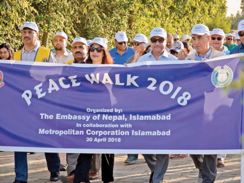 mayor anser aziz and nepalese ambassador sewa adhikari walk with diplomats and citizens in f 9 park to mark the birth of gautam buddha photo express