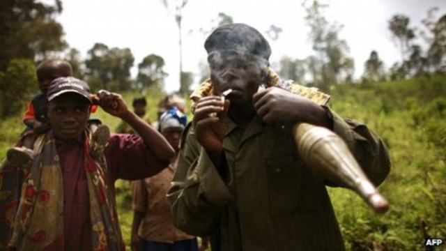 a congolese rebel holding a rocket and lighting a cigarette photo afp a congolese rebel holding a rocket and lighting a cigarette photo afp