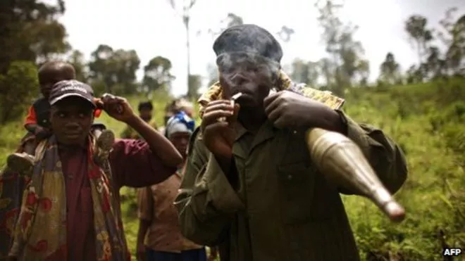 a congolese rebel holding a rocket and lighting a cigarette photo afp a congolese rebel holding a rocket and lighting a cigarette photo afp