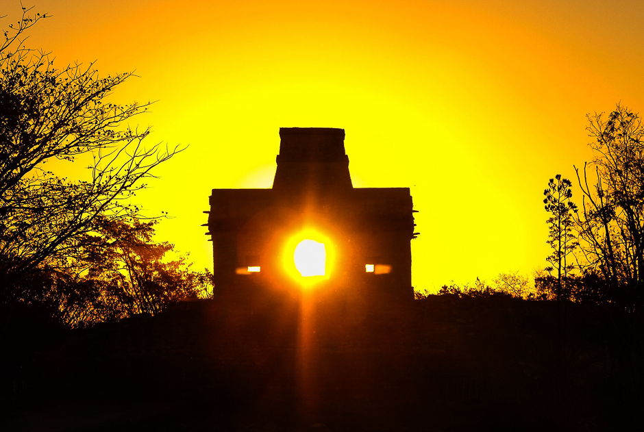 the sun shines directly through the door of the seven dolls temple in the maya ruins of dzibilchaltun in the mexican state of yucatan as it rises on the spring equinox photo afp