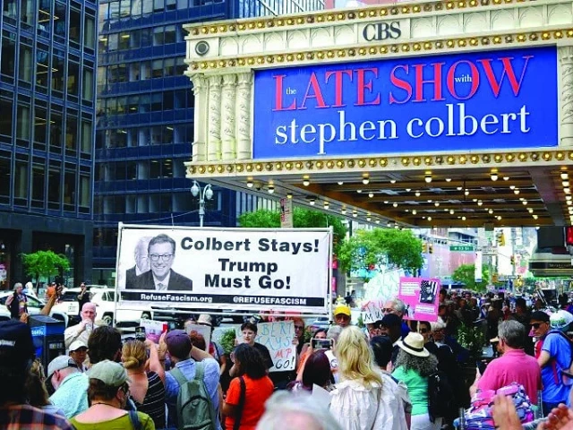 protesters hold placards supporting colbert photo afp protesters hold placards supporting colbert photo afp