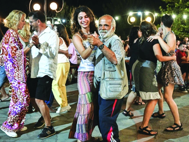 anyone can lock arms and join in the dance tradition photo afp