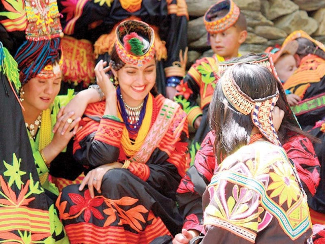 local women attired in traditional dresses enjoy the festivities photo file