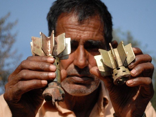 a man displaysmortar shrapnel allegedly fired across the line of control loc between pakistan and india in the kotli sector of azad kashmir on october 8 2014 photo afp