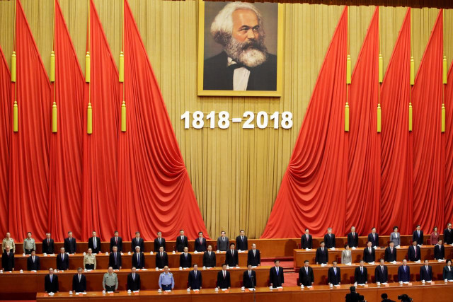 chinese president xi jinping and other officials sing the national anthem at an event commemorating the 200th birth anniversary of karl marx in beijing china photo reuters chinese president xi jinping and other officials sing the national anthem at an event commemorating the 200th birth anniversary of karl marx in beijing china photo reuters