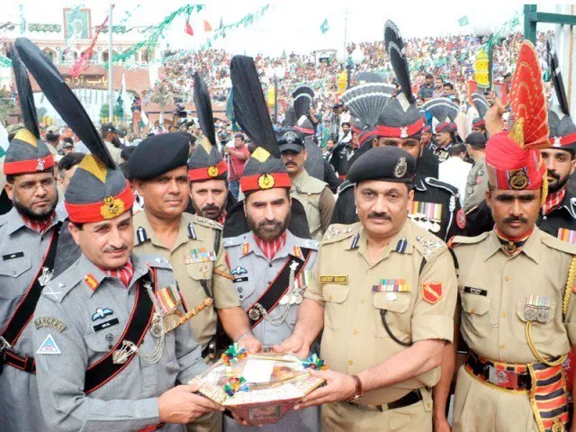 in this file photo pakistan and indian border security troops share sweets at wagah border photo afp in this file photo pakistan and indian border security troops share sweets at wagah border photo afp