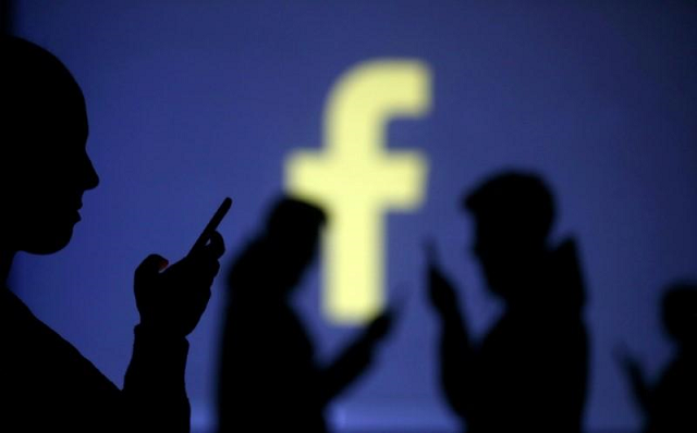 silhouettes of mobile users are seen next to a screen projection of facebook logo in this picture illustration taken march 28 2018 photo reuters silhouettes of mobile users are seen next to a screen projection of facebook logo in this picture illustration taken march 28 2018 photo reuters