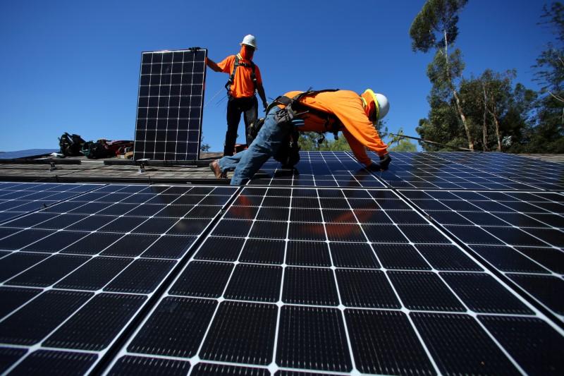 solar installers from baker electric place solar panels on the roof of a residential home in scripps ranch san diego california us photo reuters