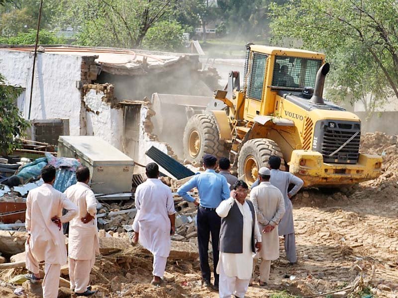 heavy machinery of the civic authority razes illegal structures set up in sector f 11 3 photo express