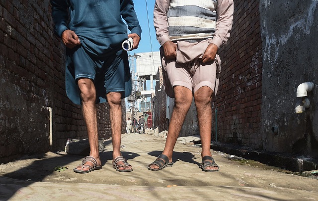 in this picture taken on february 25 2018 pakistani residents basharat ali l and naveed show their deformed lags allegedly caused by environmental factors and polluted groundwater in kot assadullah around 45km from lahore plastic chemical pharmaceutical and wire manufacturing factories in kot assadullah are widely blamed for contaminating the water local residents are forced to drink according to the lahore chamber of commerce and industries 90 percent of factories in and around the city dump their waste without treating it photo afp