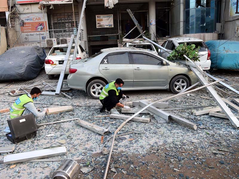 officials collect evidence after gas explosion in a hotel in peshawar photo afp