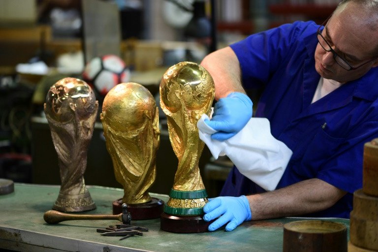 pietro brambilla an artisan at the bertoni workshop cleans a replica world cups and also the real thing photo afp