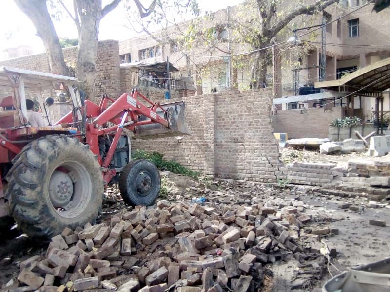 a tractor is used to tear down a barricade in cantonment area photo express