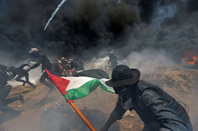 palestinian demonstrators run for cover from israeli fire and tear gas during a protest against u s embassy move to jerusalem and ahead of the 70th anniversary of nakba at the israel gaza border in the southern gaza strip may 14 2018 photo reuters palestinian demonstrators run for cover from israeli fire and tear gas during a protest against u s embassy move to jerusalem and ahead of the 70th anniversary of nakba at the israel gaza border in the southern gaza strip may 14 2018 photo reuters