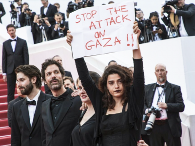 stop attack on gaza lebanese actor draws attention with placard at cannes stop attack on gaza lebanese actor draws attention with placard at cannes