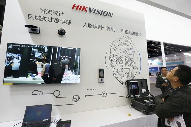 visitors are seen at a booth of security camera supplier hikvision digital technology during an expo at the national convention center in beijing china march 12 2018 picture taken march 12 2018 photo reuters