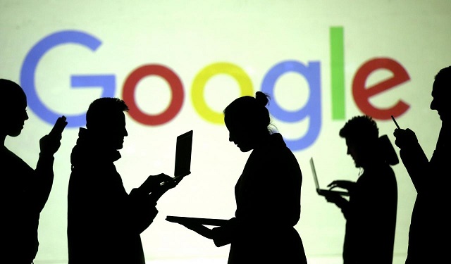 silhouettes of laptop and mobile device users are seen next to a screen projection of google logo in this picture illustration taken march 28 2018 photo reuters