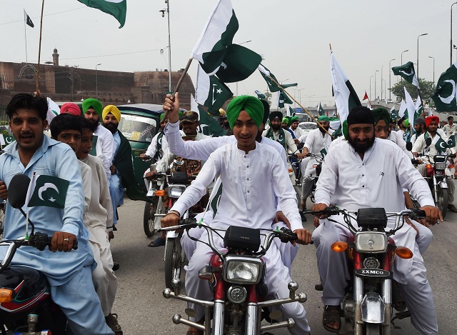 pakistani sikhs hold nationals flags as they march during the celebration to mark the country 039 s independence day in peshawar on august 14 2017 photo afp