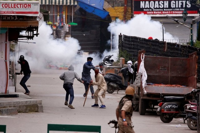 demonstrators hurl stones towards indian police during a protest against the recent killings of palestinian protesters on the gaza israel border and the us embassy move to jerusalem in srinagar may 18 2018 photo reuters