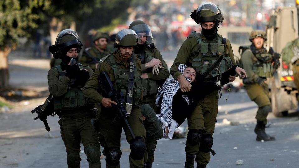 israeli soldiers detain a palestinian photo reuters