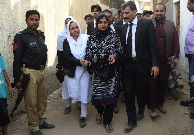 asma nawab c arrives with her lawyer javed chatari 2r before entering her house after her release in karachi photo afp