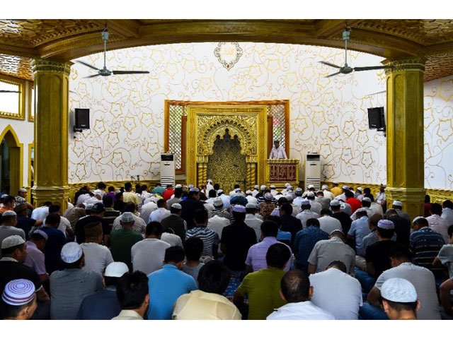 muslims gather for friday prayers inside a mosque in shanghai mosques are now being urged to fly the national flag photo afp