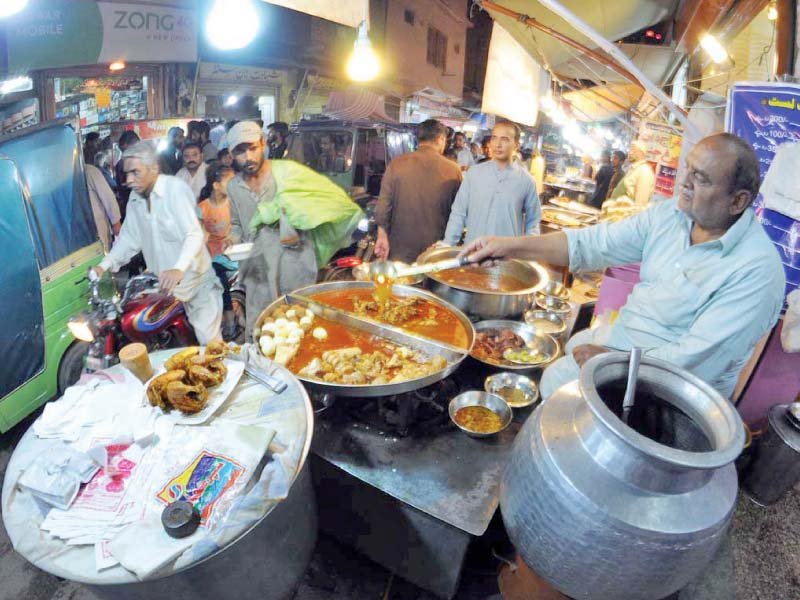 people buy siri paya and lassi at karatarpura food street photo agencies