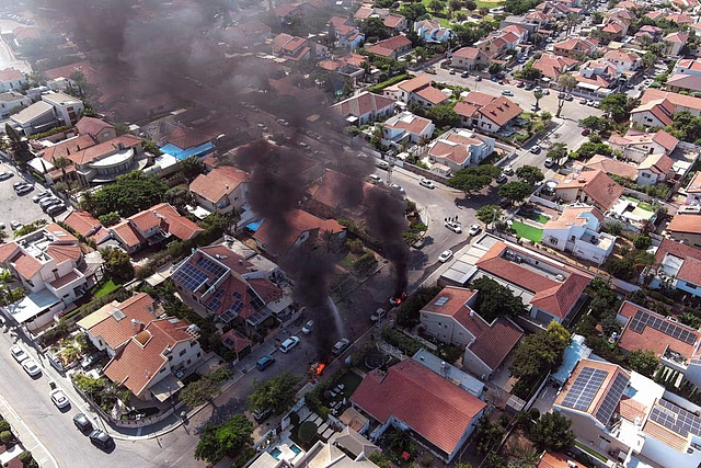 An aerial view shows vehicles on fire as rockets are launched from the Gaza Strip, in Ashkelon, southern Israel October 7: REUTERs