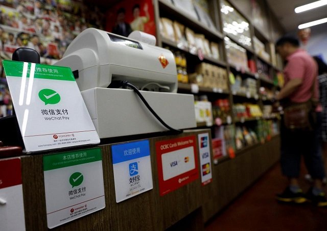 signs accepting wechat pay and alipay are displayed at a shop in singapore may 22 2018 picture taken may 22 2018 photo reuters