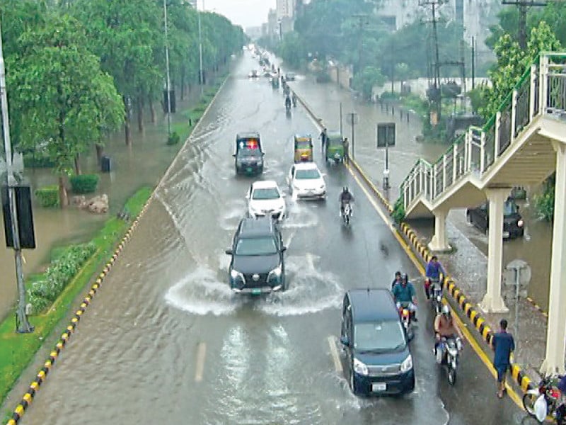 heavy rainfall transforms the gulberg road into a stream causing disruption for commuters photo imtiaz khan express