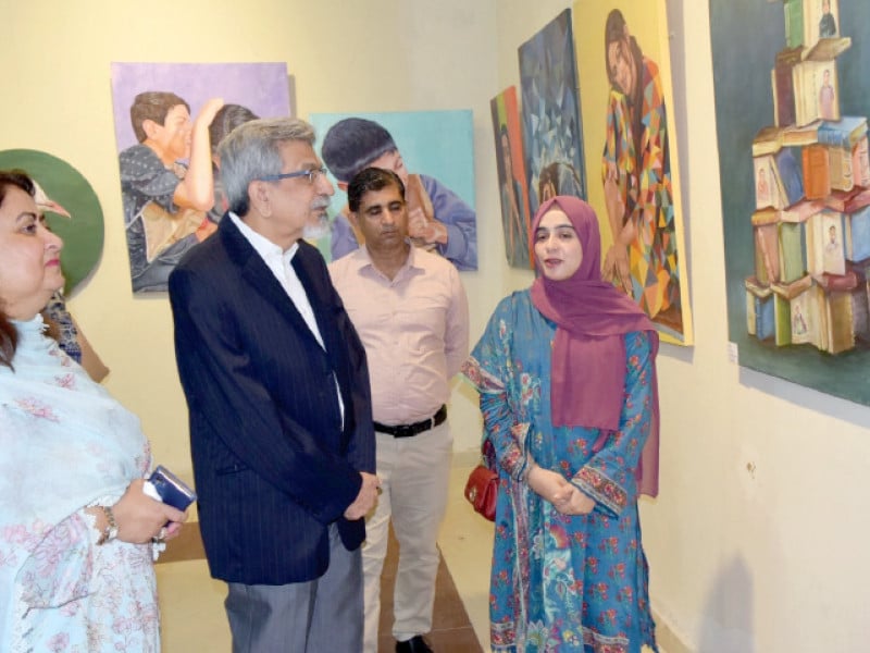 students explain the concept behind their artworks to visitors at the art exhibition organised by pac and rawalpindi women university photo express