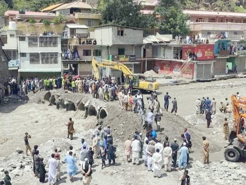 citizens stranded for six days cross the munawar nullah to reach their destination after local authorities construct a makeshift causeway in balakot photo zulfiqar ali express