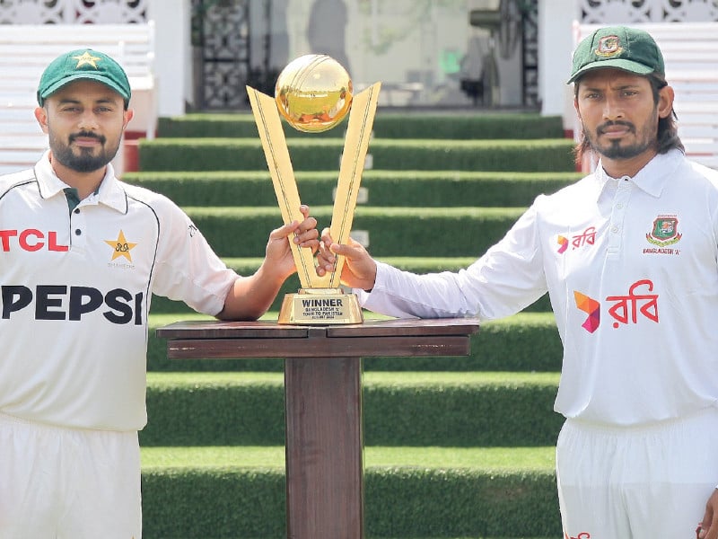 saud shakeel l and anamul haque r pose with the four day game trophy photo afp