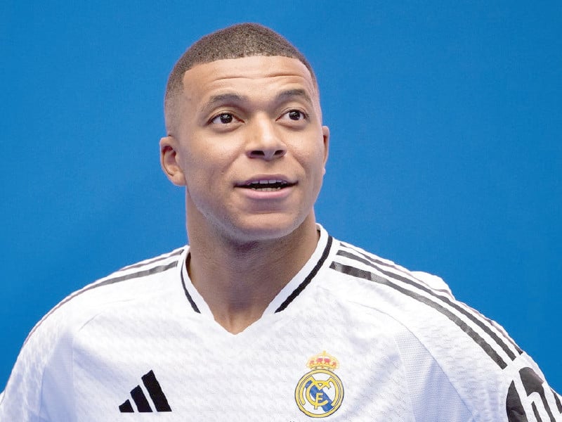 striker kylian mbappe poses in his new real madrid kit photo afp