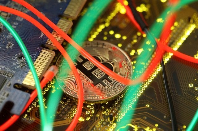 representation of the bitcoin virtual currency standing on the pc motherboard is seen in this illustration picture february 3 2018 photo reuters