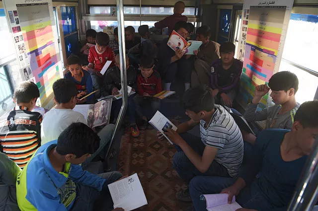 afghan youths read books in a mobile library bus in kabul the door of the blue bus slides open and dozens of children excitedly bound up the steps eager to get their hands on hard to find books in kabul 039 s first mobile library photo afp afghan youths read books in a mobile library bus in kabul the door of the blue bus slides open and dozens of children excitedly bound up the steps eager to get their hands on hard to find books in kabul 039 s first mobile library photo afp