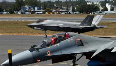 a f 35 fighter jet moves past indian air force s sukhoi su 30mki fighter jet parked on tarmac during the aero india 2025 air show at yelahanka air base in bengaluru india february 11 2025 photo reuters