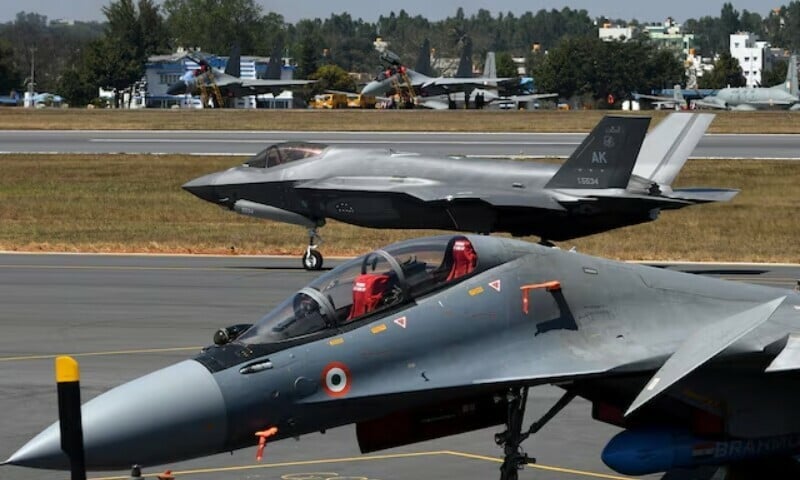 a f 35 fighter jet moves past indian air force s sukhoi su 30mki fighter jet parked on tarmac during the aero india 2025 air show at yelahanka air base in bengaluru india february 11 2025 photo reuters