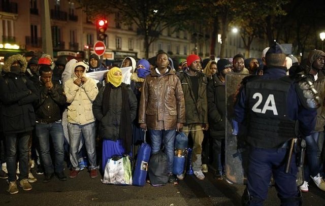 migrants wait before entering buses paris france photo reuters
