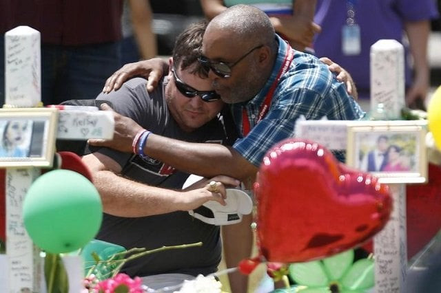 people embrace at a makeshift memorial in memory of the victims killed in a shooting at santa fe high school in santa fe texas may 22 2018 photo reuters people embrace at a makeshift memorial in memory of the victims killed in a shooting at santa fe high school in santa fe texas may 22 2018 photo reuters