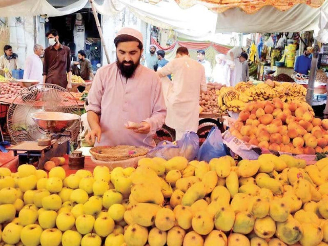a vendor arranges mangoes on his pushcart photo nni a vendor arranges mangoes on his pushcart photo nni