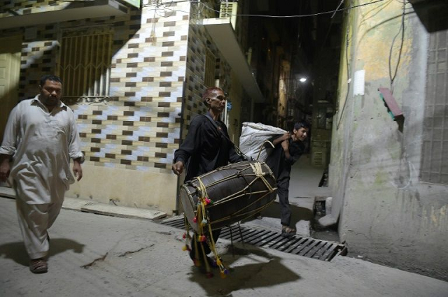 drummer lal hussein walks through streets photo afp
