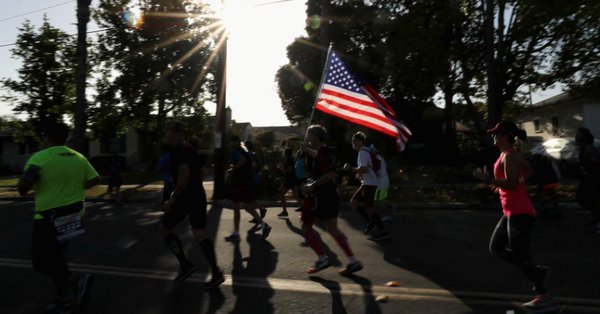 a runner waves an american flag during the synchrony rock 039 n 039 roll san diego marathon on june 3 2018 in san diego california photo afp