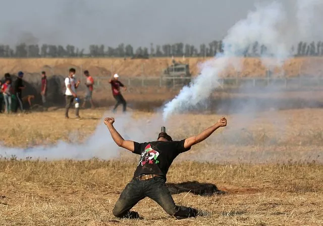 a palestinian protester holds a tear gas canister in his mouth during a demonstration along the border with israel east of khan yunis in the southern gaza strip on june 1 2018 photo afp a palestinian protester holds a tear gas canister in his mouth during a demonstration along the border with israel east of khan yunis in the southern gaza strip on june 1 2018 photo afp