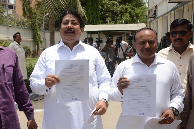 ppp candidates dr suresh kumar and anthony naveed showing nomination forms photo mohammad azeem