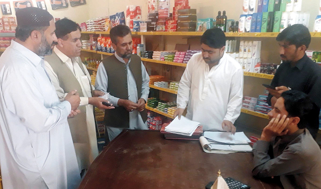 district administration officials checking the price list photo express district administration officials checking the price list photo express