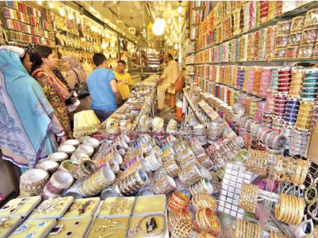 women select bangles at a stall photo file