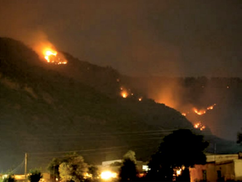 a fire on the margalla hills photo file