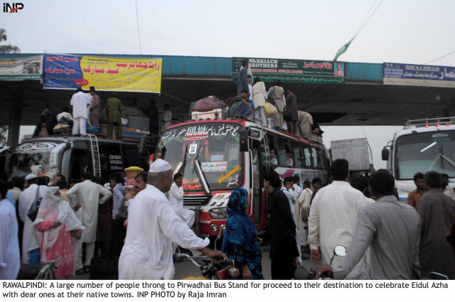 commuters load their belongings on to buses at a stand in rawalpindi photo inp commuters load their belongings on to buses at a stand in rawalpindi photo inp