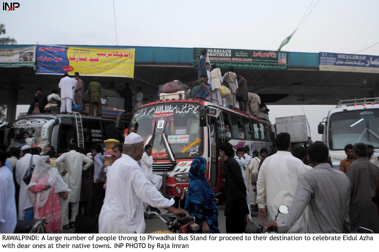 commuters load their belongings on to buses at a stand in rawalpindi photo inp